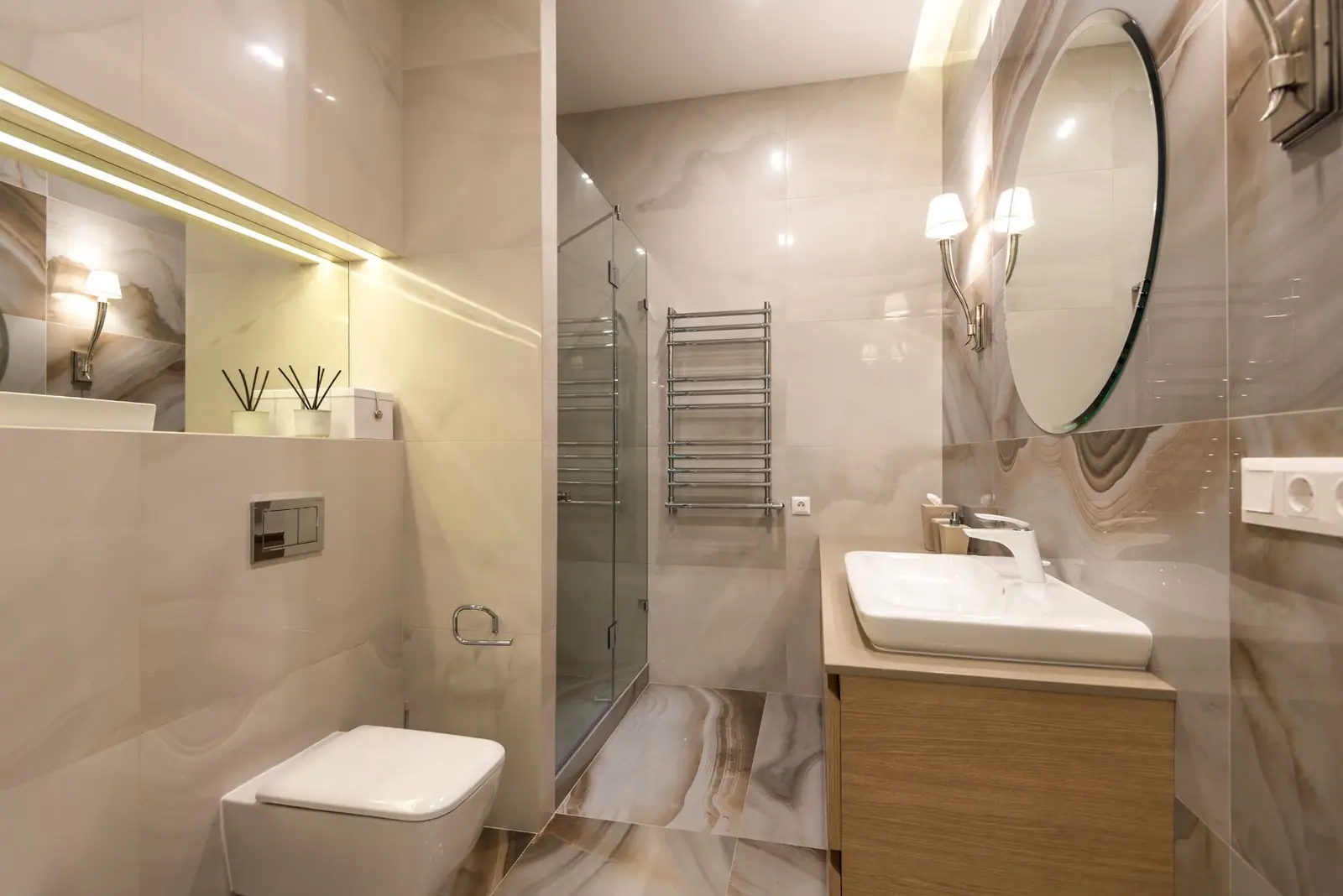 Bathroom with large-format stone-look tile, glass shower enclosure, floating vanity and wall-hung toilet
