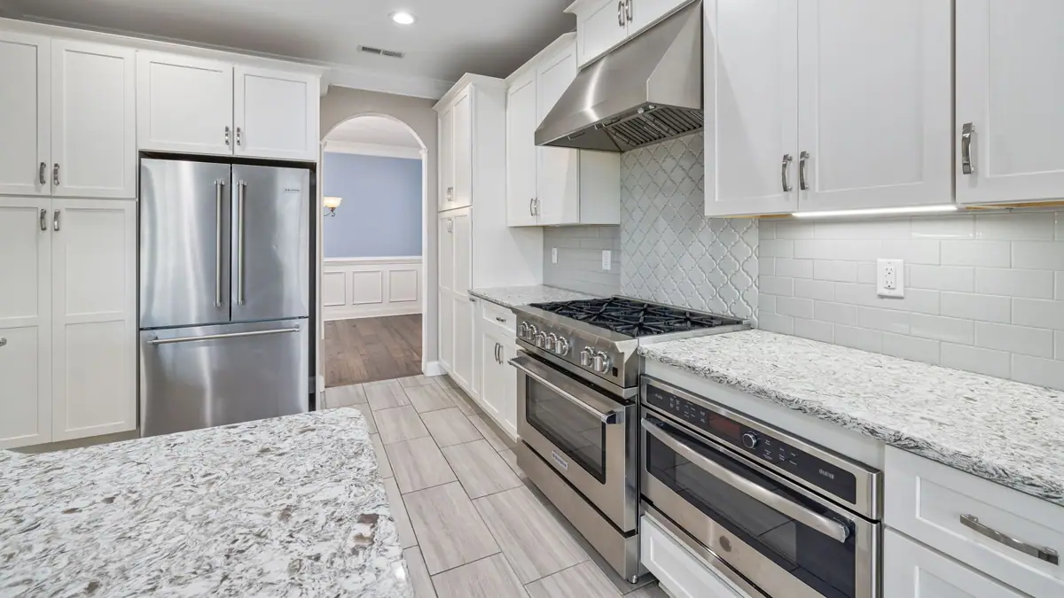 Kitchen remodel cost: finished kitchen with white shaker cabinets and granite countertops