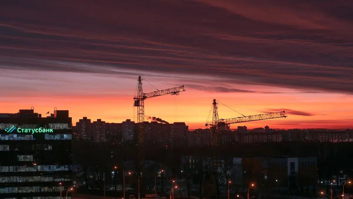 NYC building permits: construction cranes above the New York City skyline at dusk